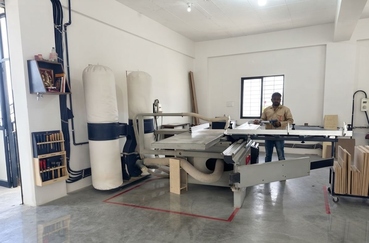 A worker cutting boards on the panel saw in our factory